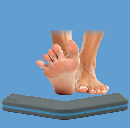A person using an Ultimate Body Press yoga block to spread and press their toes for improved foot mobility.